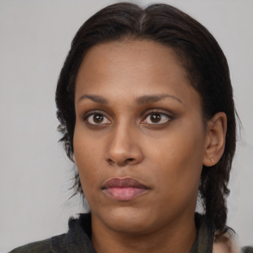 Neutral black young-adult female with medium  brown hair and brown eyes
