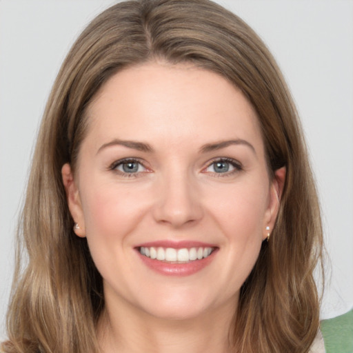 Joyful white young-adult female with medium  brown hair and grey eyes