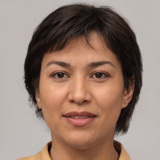 Joyful asian adult female with medium  brown hair and brown eyes