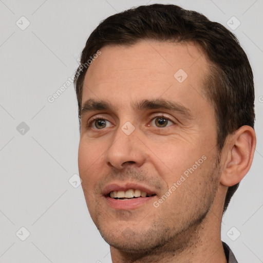 Joyful white adult male with short  brown hair and brown eyes