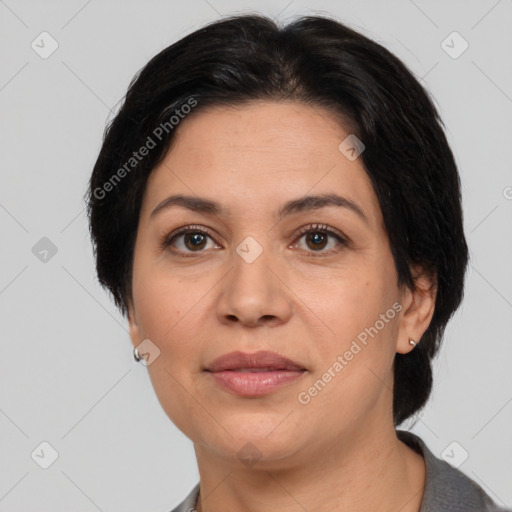 Joyful latino adult female with medium  brown hair and brown eyes