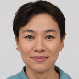 Joyful asian young-adult female with short  brown hair and brown eyes