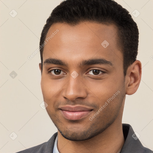 Joyful black young-adult male with short  brown hair and brown eyes