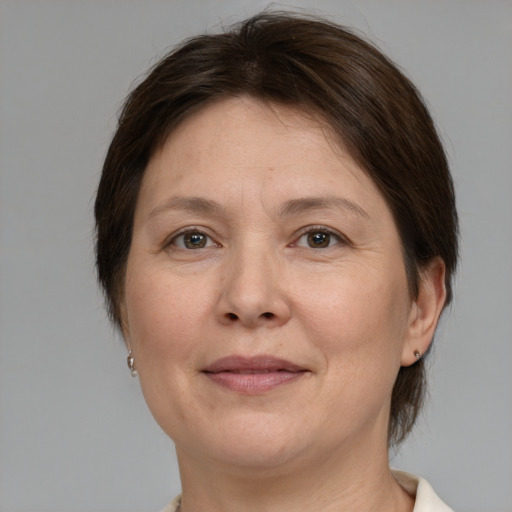 Joyful white adult female with medium  brown hair and brown eyes