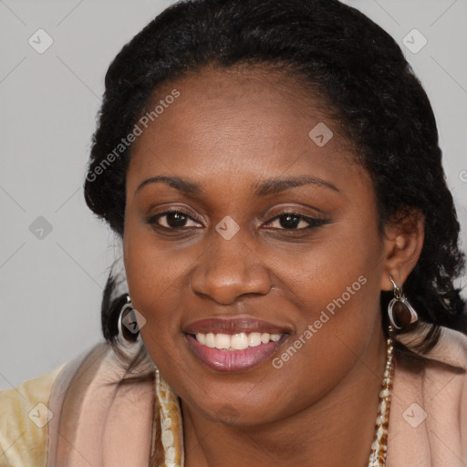 Joyful black young-adult female with long  brown hair and brown eyes