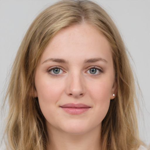 Joyful white young-adult female with long  brown hair and blue eyes