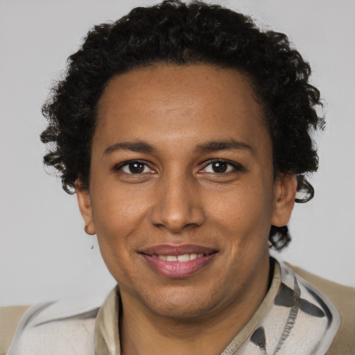 Joyful black adult female with short  brown hair and brown eyes