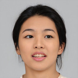 Joyful asian young-adult female with medium  black hair and brown eyes