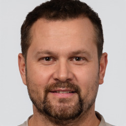 Joyful white adult male with short  brown hair and brown eyes