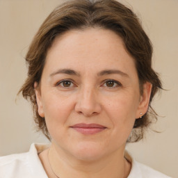 Joyful white adult female with medium  brown hair and brown eyes