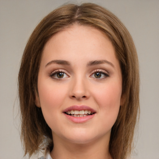 Joyful white young-adult female with medium  brown hair and green eyes