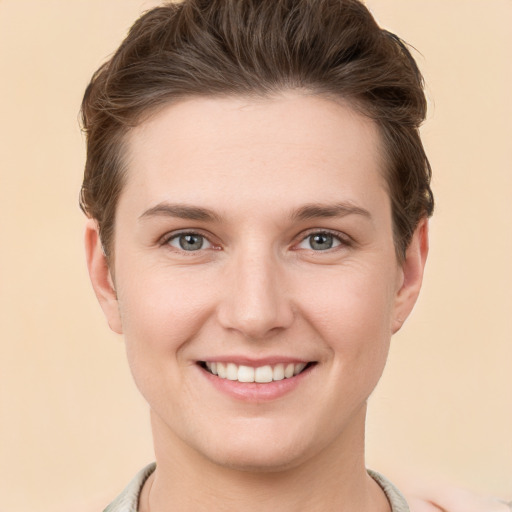 Joyful white young-adult female with short  brown hair and grey eyes