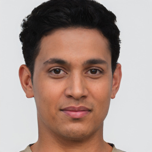 Joyful latino young-adult male with short  black hair and brown eyes