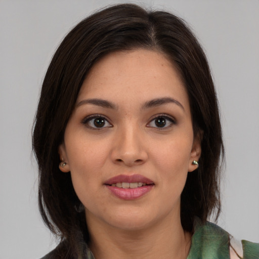 Joyful latino young-adult female with medium  brown hair and brown eyes