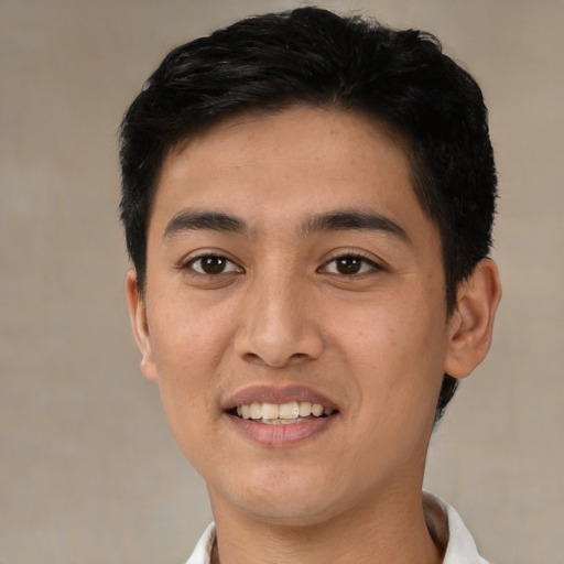 Joyful latino young-adult male with short  black hair and brown eyes