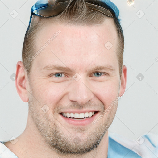 Joyful white adult male with short  brown hair and blue eyes