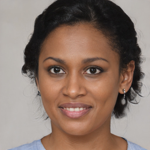Joyful black young-adult female with medium  brown hair and brown eyes