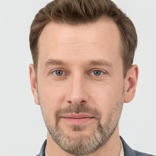 Joyful white adult male with short  brown hair and grey eyes