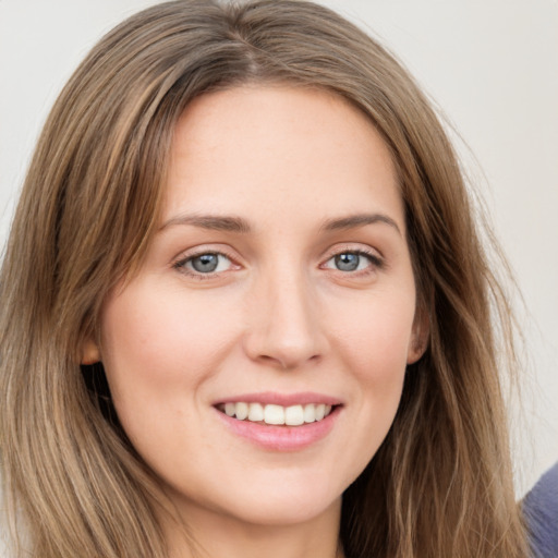 Joyful white young-adult female with long  brown hair and grey eyes