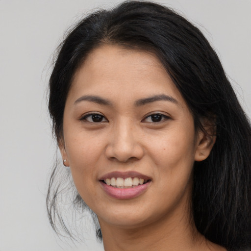 Joyful asian young-adult female with long  brown hair and brown eyes