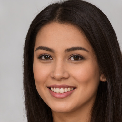 Joyful white young-adult female with long  brown hair and brown eyes