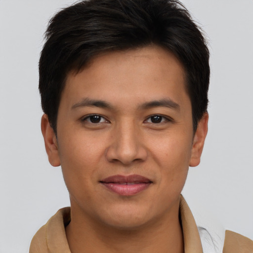 Joyful asian young-adult male with short  brown hair and brown eyes