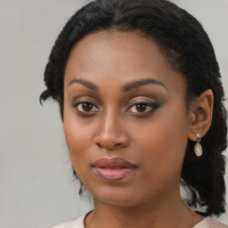 Joyful black young-adult female with medium  brown hair and brown eyes