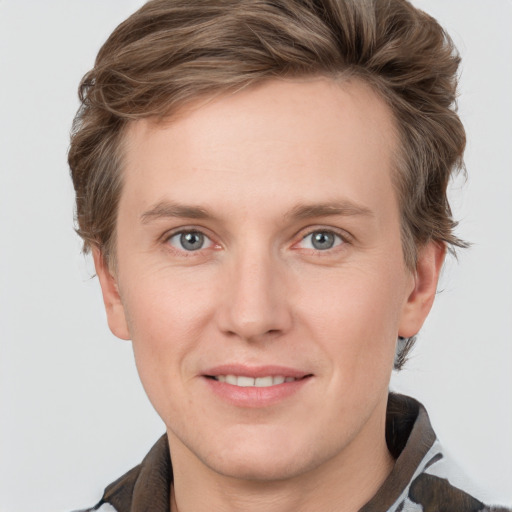 Joyful white adult male with short  brown hair and grey eyes