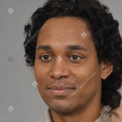 Joyful black young-adult male with short  black hair and brown eyes