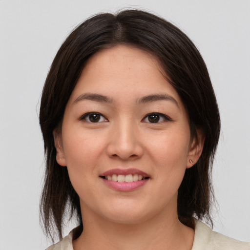 Joyful asian young-adult female with medium  brown hair and brown eyes