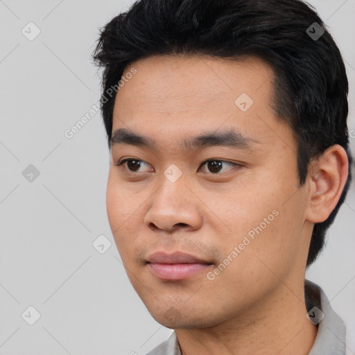 Joyful asian young-adult male with short  black hair and brown eyes