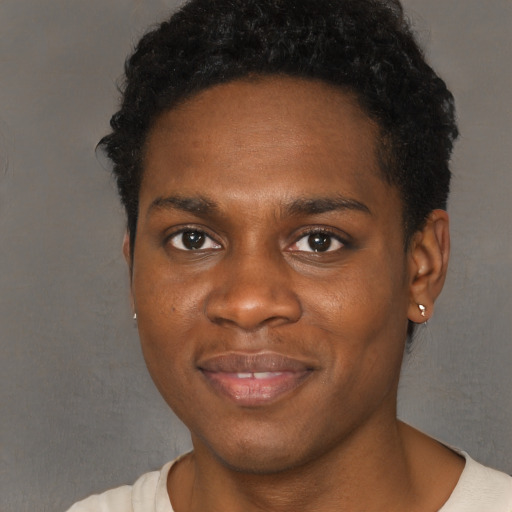 Joyful black young-adult male with short  brown hair and brown eyes