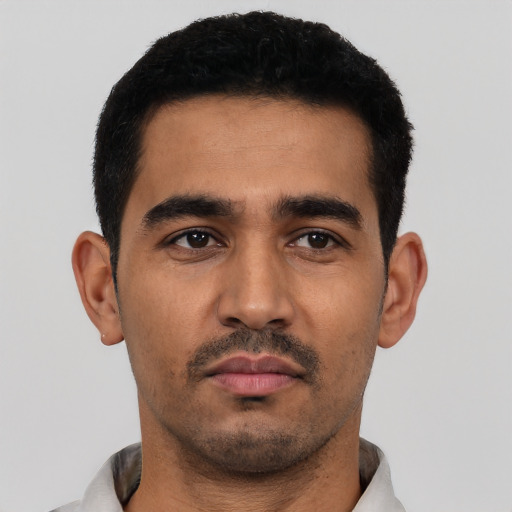 Neutral latino young-adult male with short  black hair and brown eyes