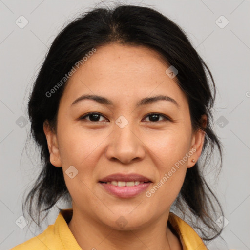 Joyful asian adult female with medium  brown hair and brown eyes