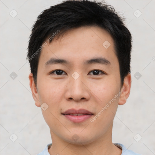 Joyful asian young-adult male with short  black hair and brown eyes