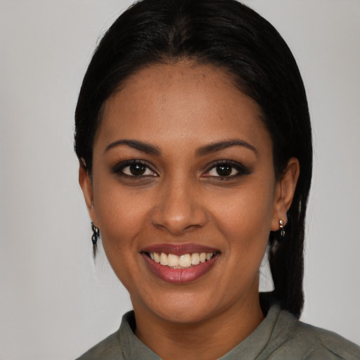 Joyful black young-adult female with medium  black hair and brown eyes