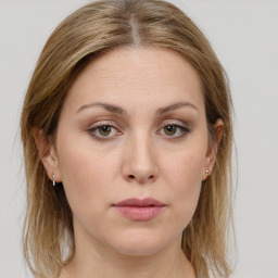 Joyful white young-adult female with long  brown hair and green eyes