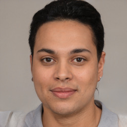 Joyful latino young-adult male with short  black hair and brown eyes