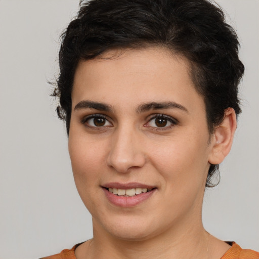 Joyful white young-adult female with short  brown hair and brown eyes