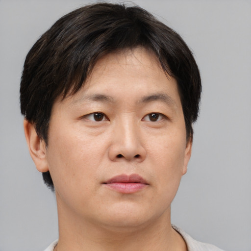 Neutral asian young-adult male with short  brown hair and brown eyes