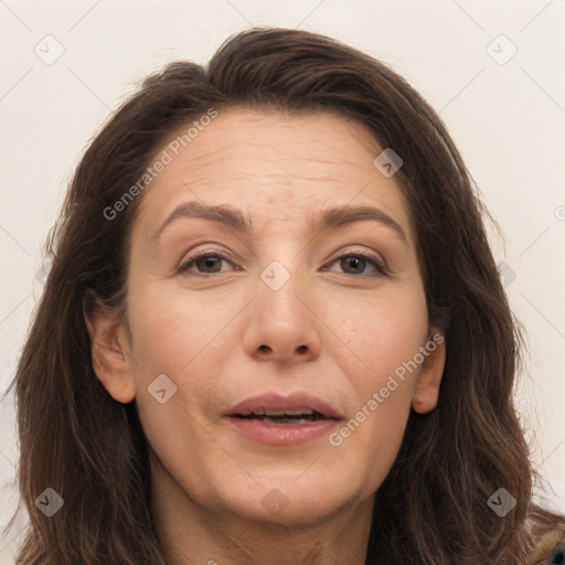 Joyful white adult female with long  brown hair and brown eyes