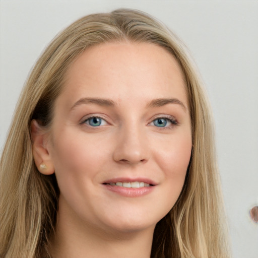 Joyful white young-adult female with long  brown hair and blue eyes