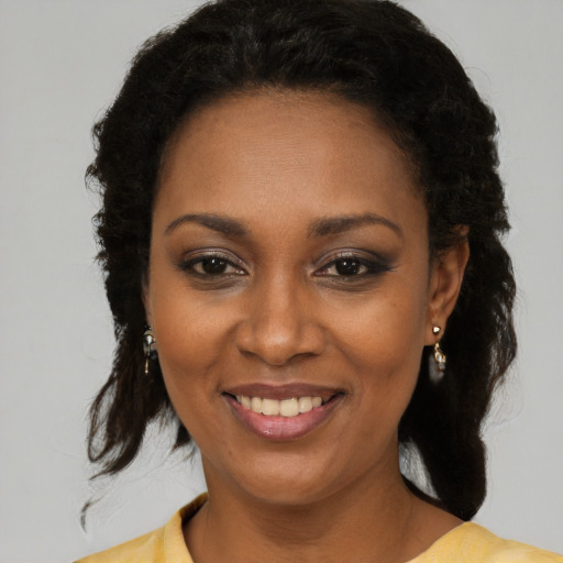 Joyful black young-adult female with medium  brown hair and brown eyes