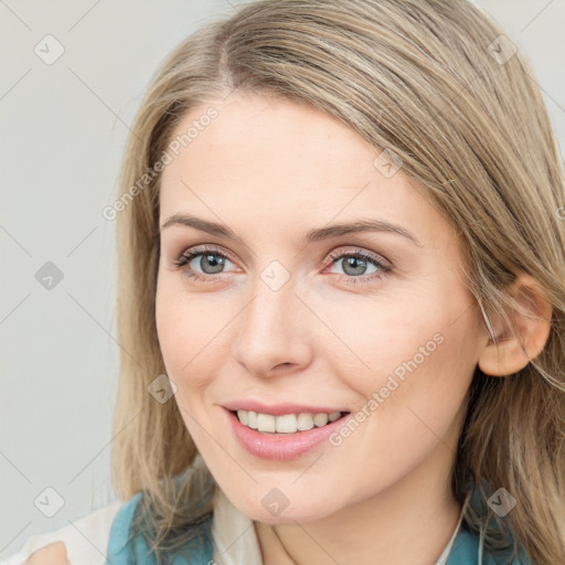 Joyful white young-adult female with long  brown hair and blue eyes