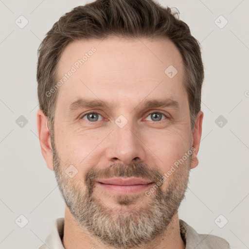 Joyful white adult male with short  brown hair and grey eyes