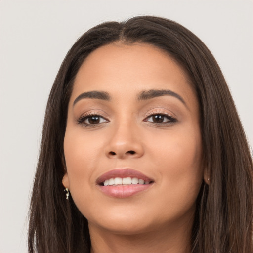 Joyful white young-adult female with long  brown hair and brown eyes