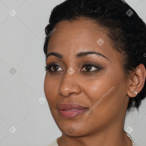 Joyful black young-adult female with short  black hair and brown eyes