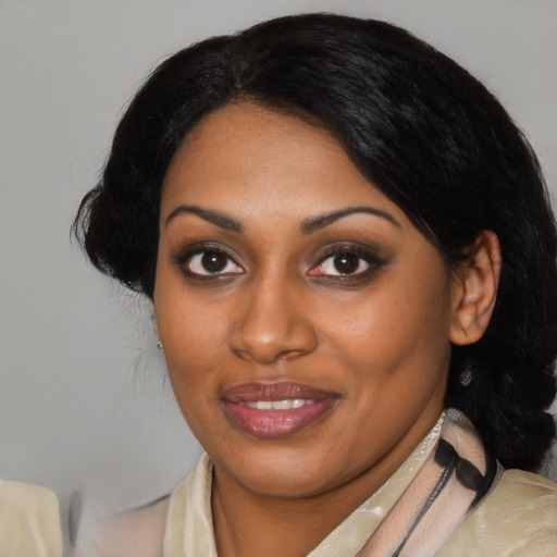 Joyful black young-adult female with medium  black hair and brown eyes