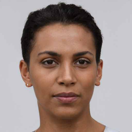 Joyful latino young-adult female with short  black hair and brown eyes