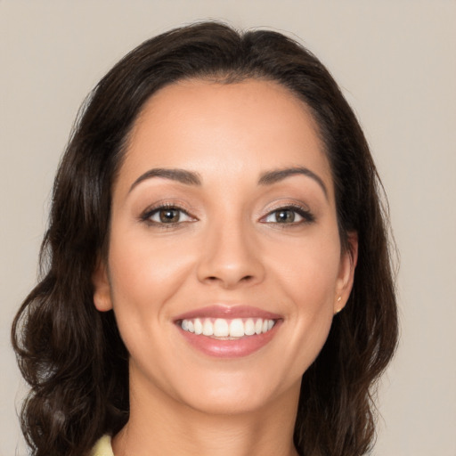 Joyful white young-adult female with long  brown hair and brown eyes